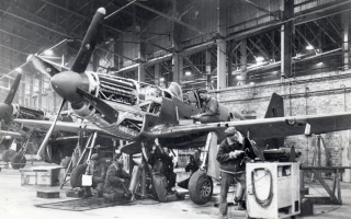USAAF Personnel work on an RAF P-51 Mustang in BAD-2's 5 hangar.